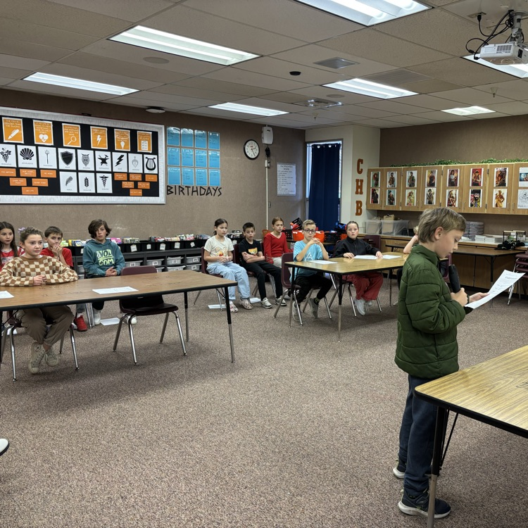 students seated in a mock courtroom holding a mock trial
