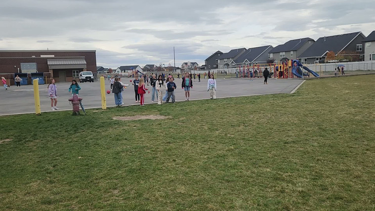 Students playing "Run and Scream" on the field.