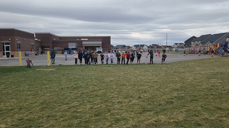 Students playing "Run and Scream" on the field.