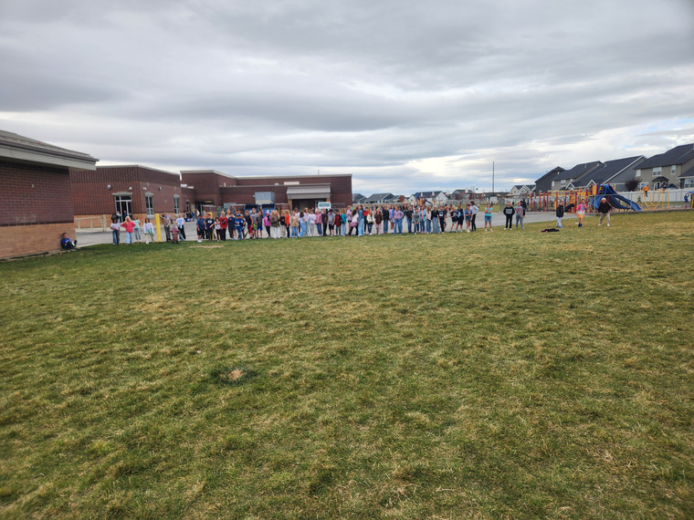 Students playing "Run and Scream" on the field.