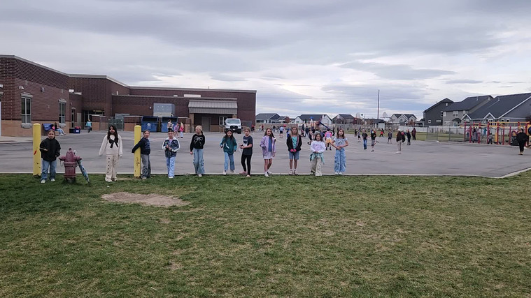 Students playing "Run and Scream" on the field.