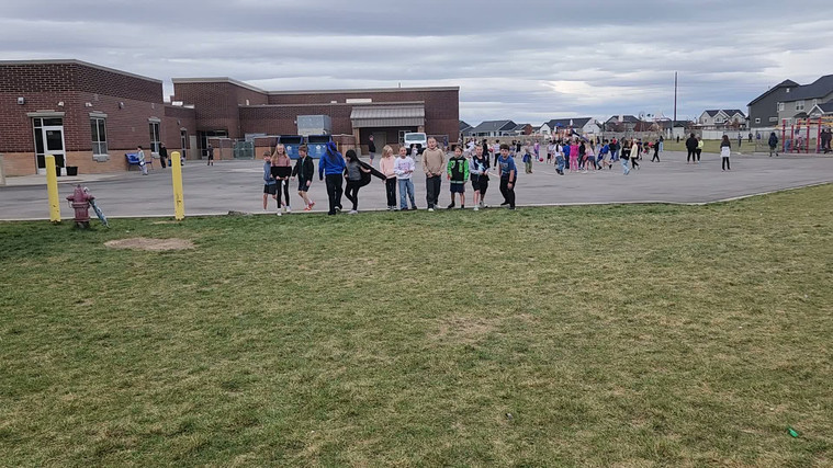 Students playing "Run and Scream" on the field.