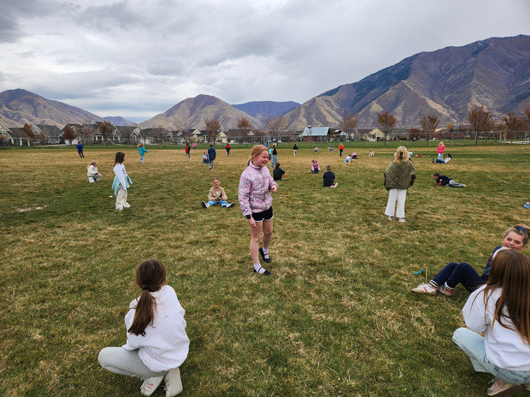 Students playing "Run and Scream" on the field.