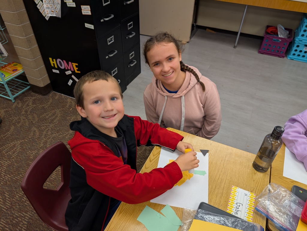 Payson Junior High Peer Leadership Class helping Mrs. Haines' first graders make pumpkins