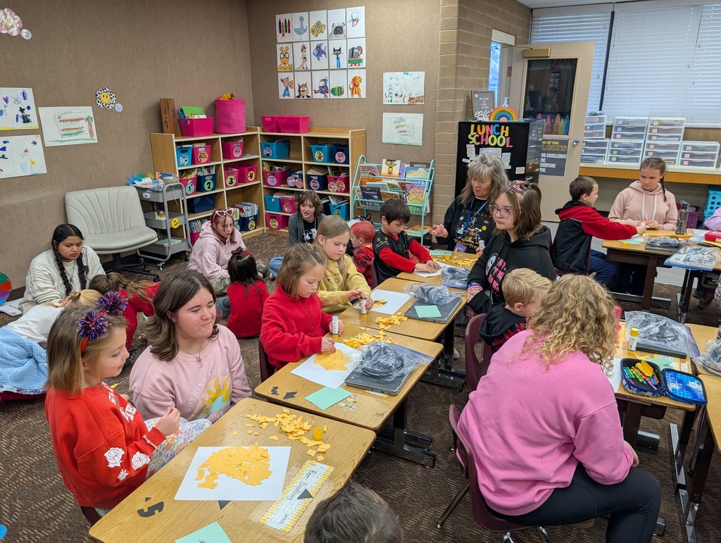 Payson Junior High Peer Leadership Class helping Mrs. Haines' first graders make pumpkins