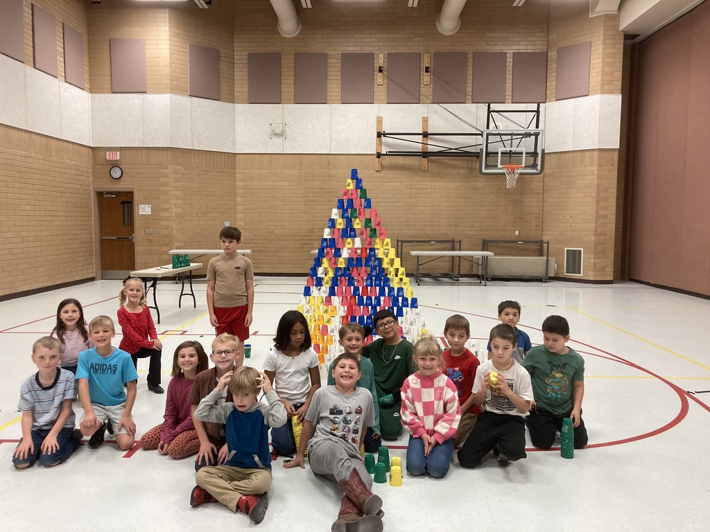 Students posing after creating cup towers