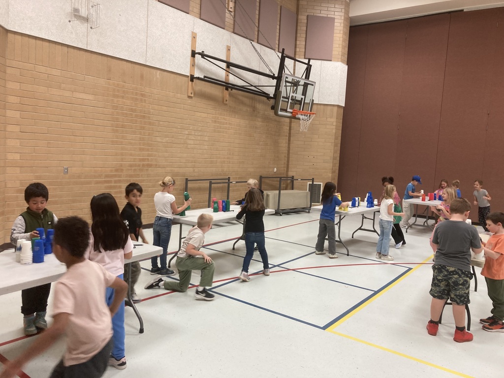 Students playing "Fox and Hound" while stacking cups