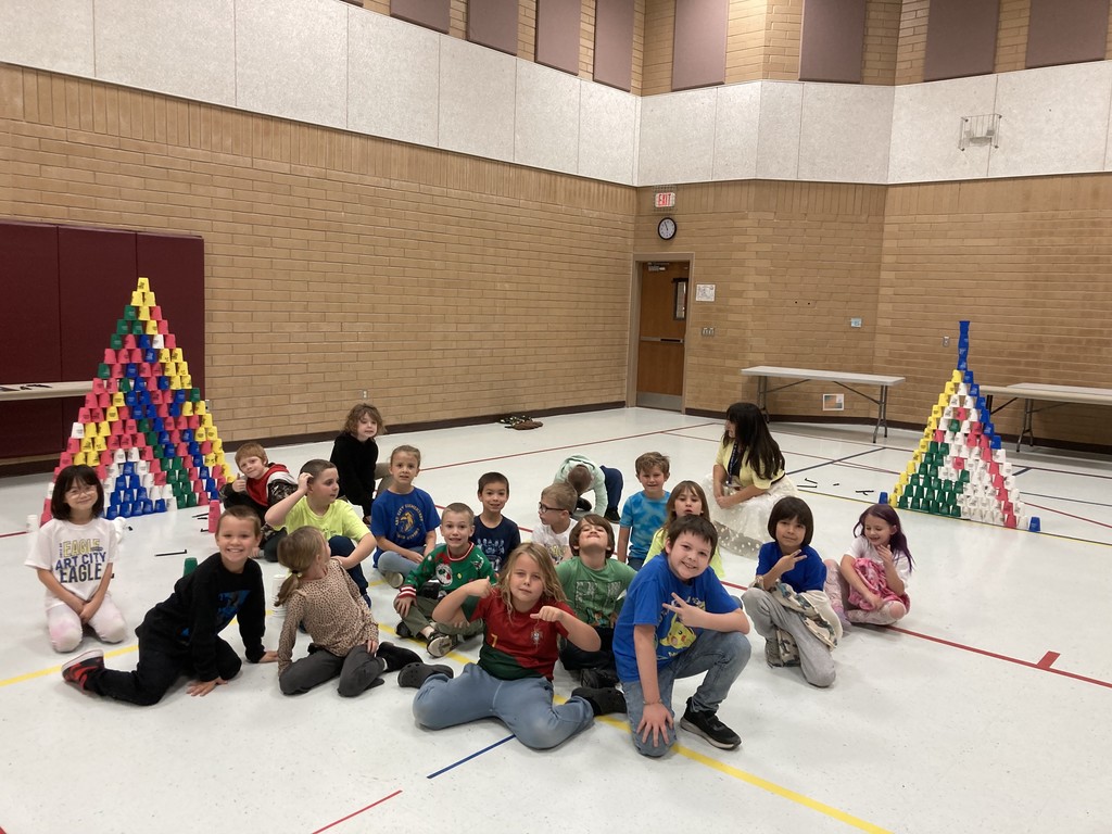 Students posing after creating cup towers