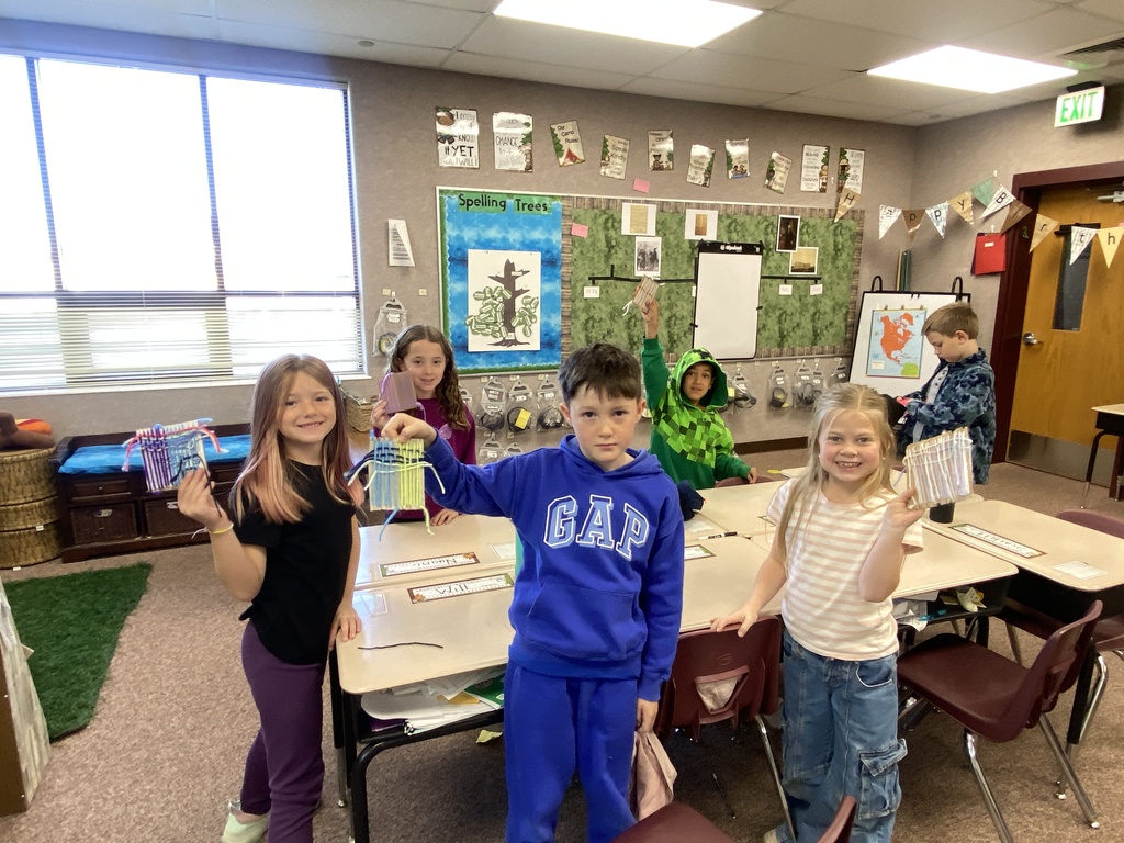 Students learning to weave