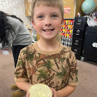 Students putting butter on bread
