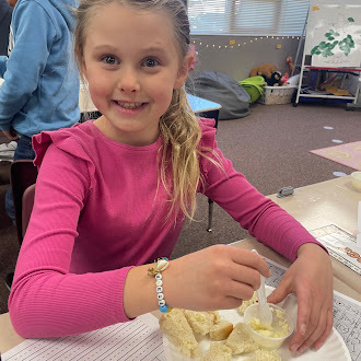 Students putting butter on bread
