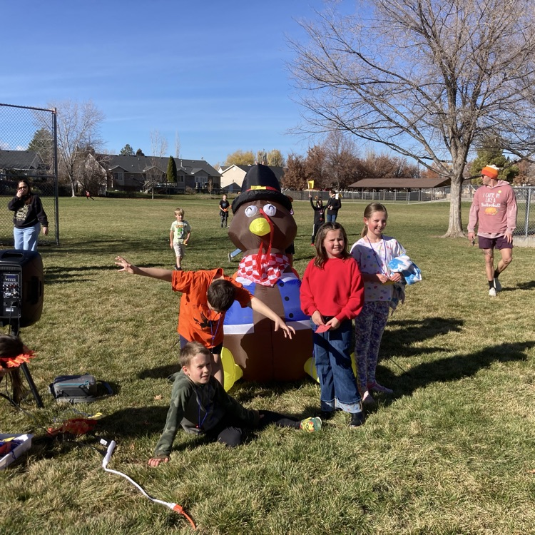 Students standing with the Turkey mascot displayed for the Turkey Trot