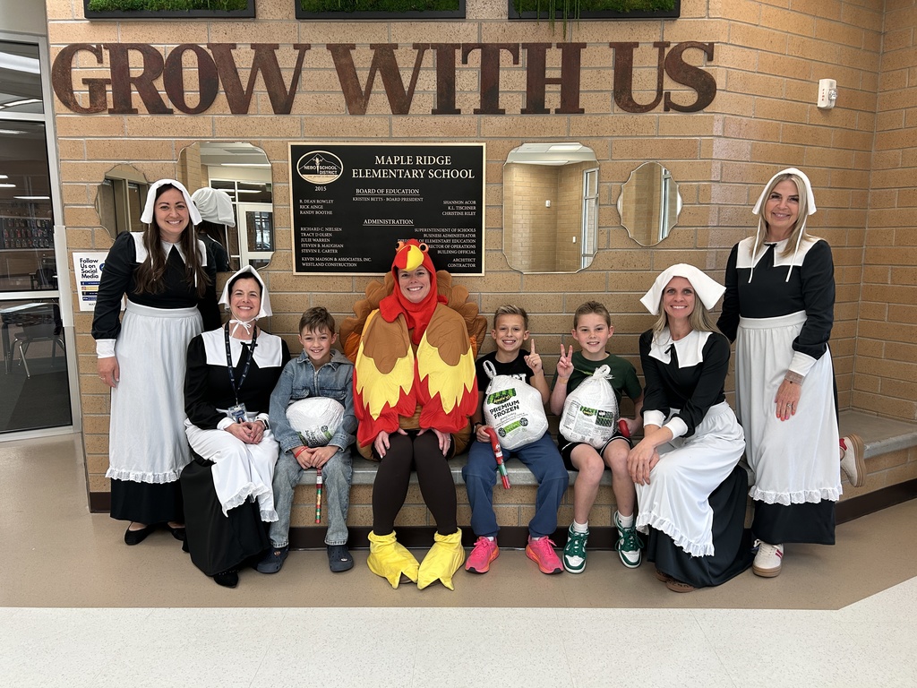 Gobble Off winners with their turkeys and a giant turkey and four pilgrim ladies.