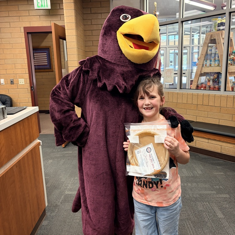 the Hawk mascot standing with a girl holding a certificate