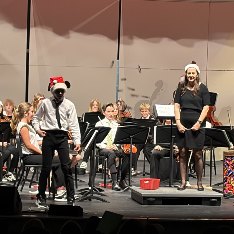 A student tossing candy to the crowd during “Name that Tune"