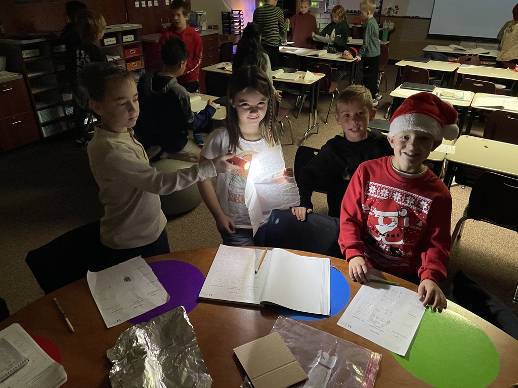 picture of kids using a flashlight and papers
