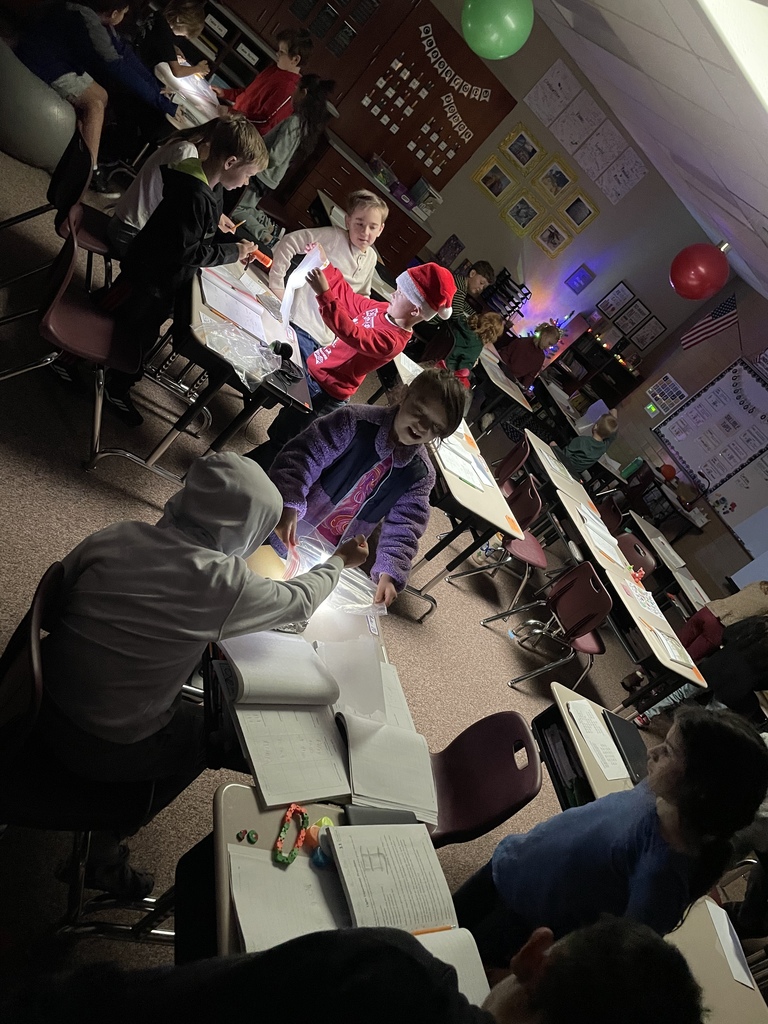 kids using flashlights at their desks