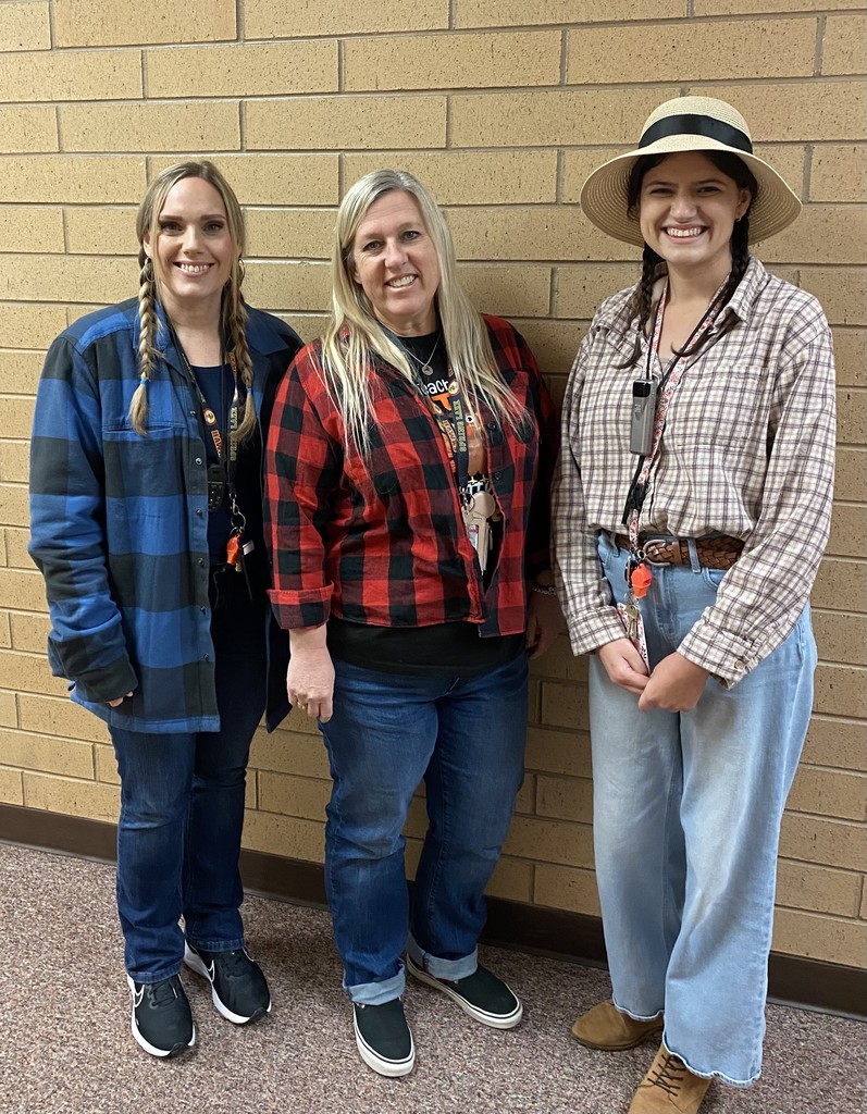 3 kindergarten teachers dressed as farmers with flannel shirts and jeans