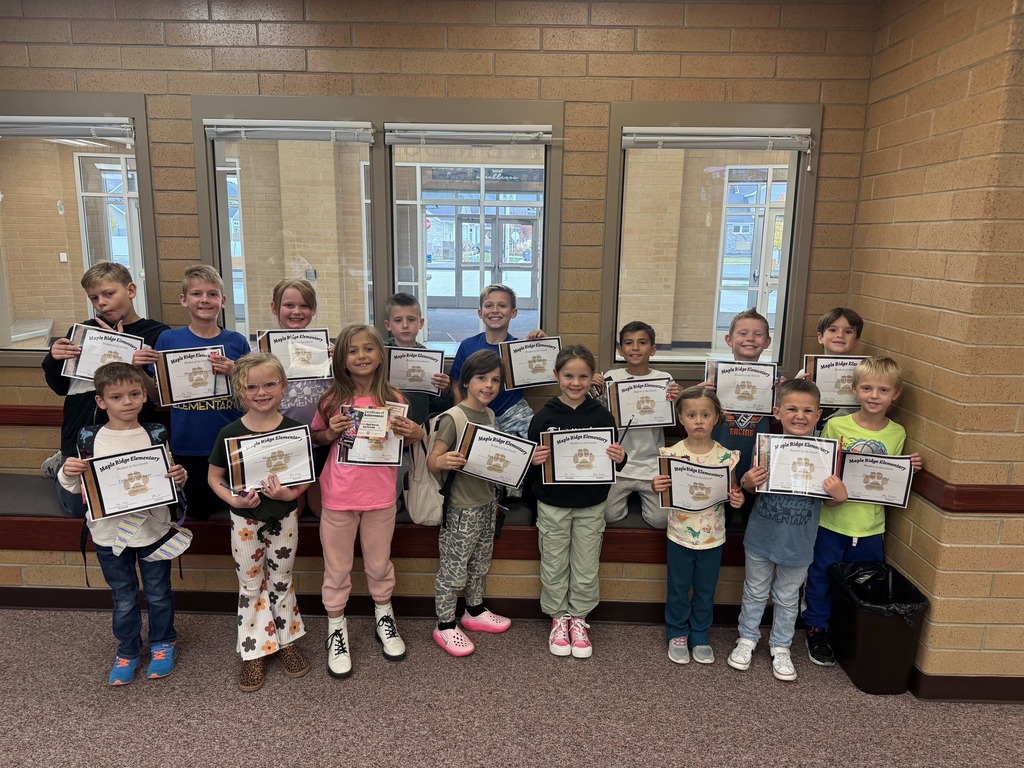 Students holding their Student of the Month certificates.