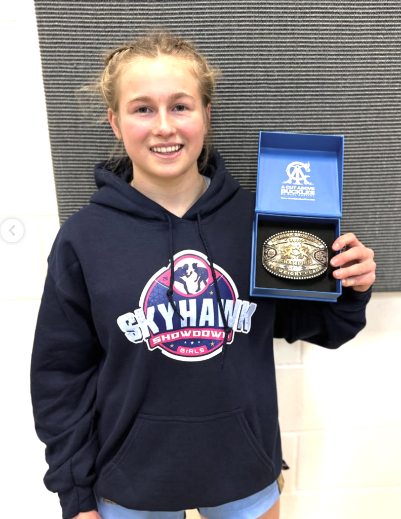 Makayla Carrick places 1st at Skyhawk Showdown. She is holding her medal.