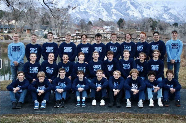 Boys wresting team in front of Salem pond bridge