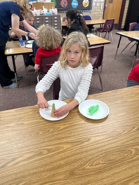Spreading icing on a ice cream cone