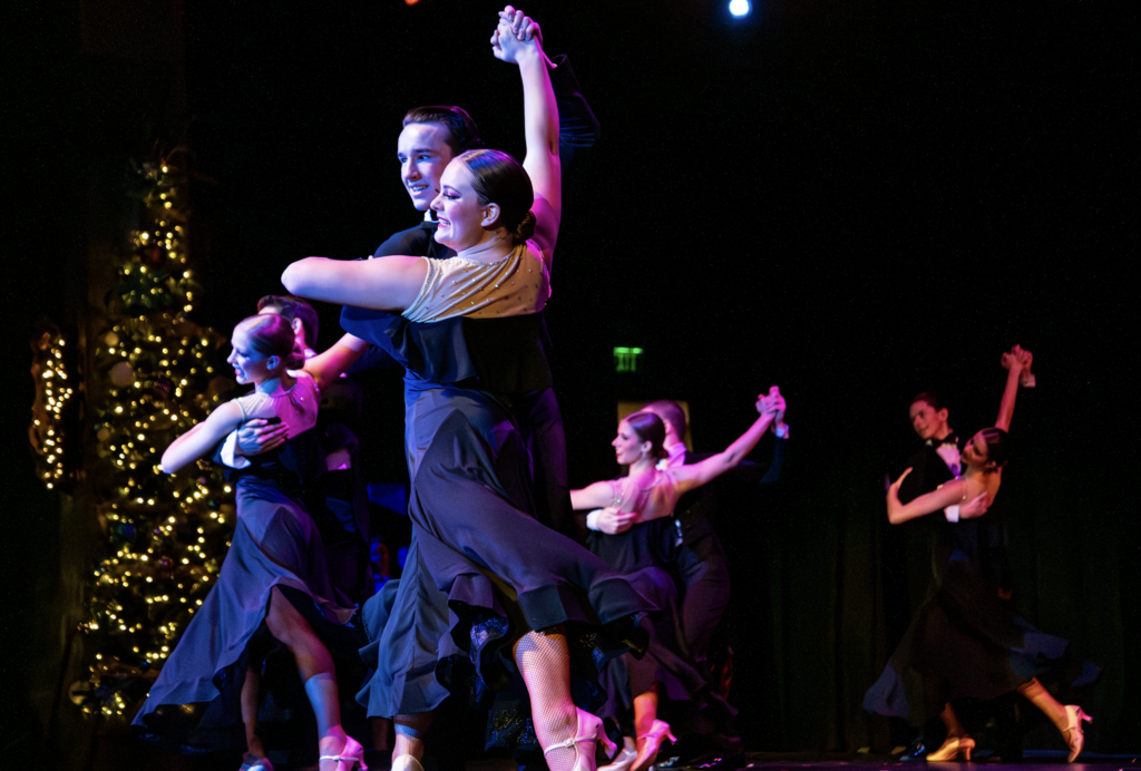 Fine arts Assembly- ballroom dance team on stage in poses