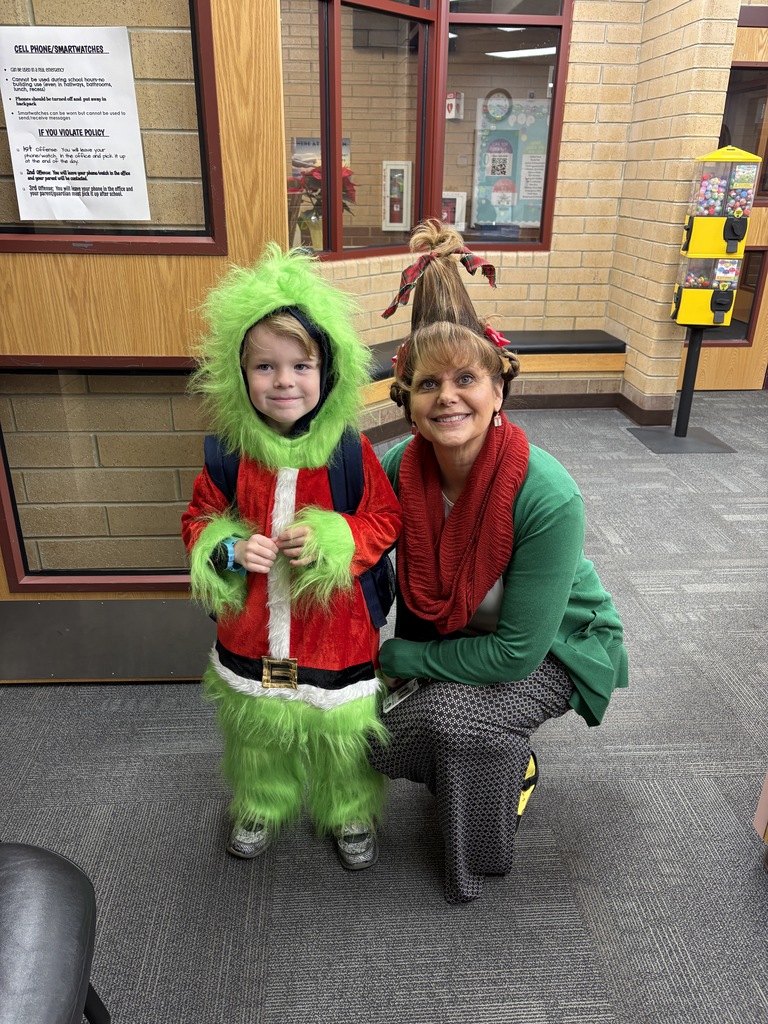 Student dressed up as the grinch and our principal dressed as cindy lou