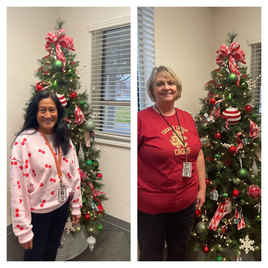 Teachers and staff standing in school wishing everyone a Merry Christmas.