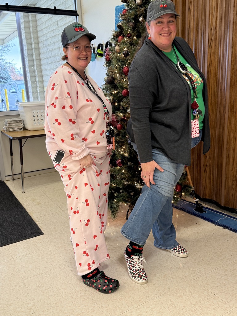 Teachers and staff standing in school wishing everyone a Merry Christmas.