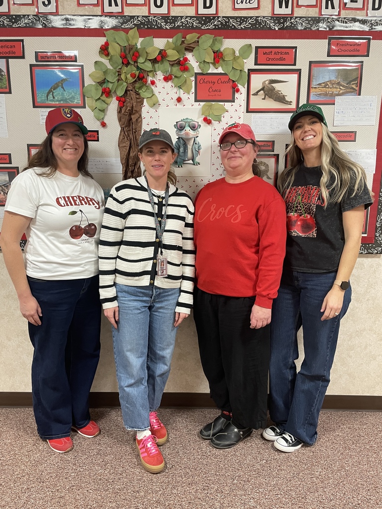 Teachers and staff standing in school wishing everyone a Merry Christmas.