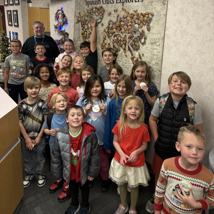 picture of students next to rock poster