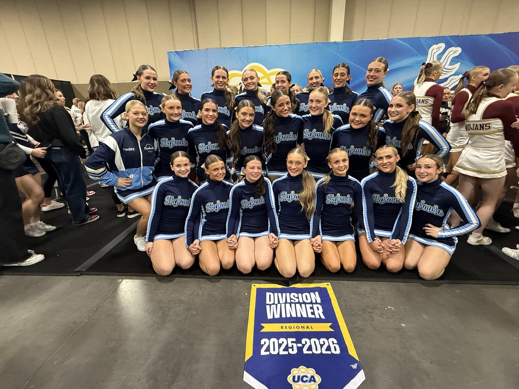 Cheer wins 1st at UCA Divisionals- team with banner