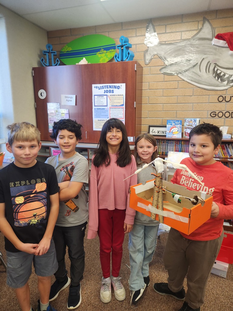 students posing with their invention 