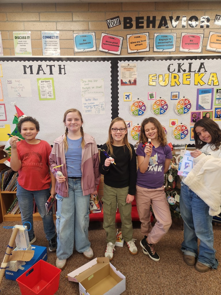 students posing with their invention 