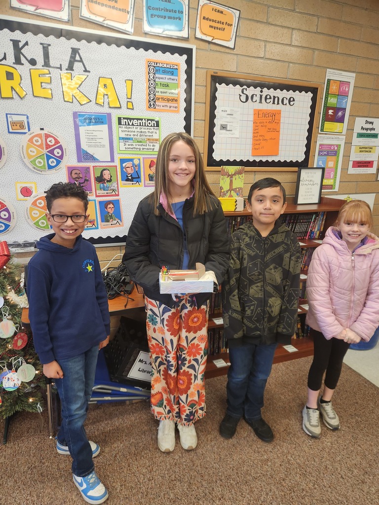 students posing with their invention 