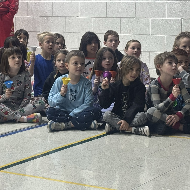 Second Grade performed with bells .