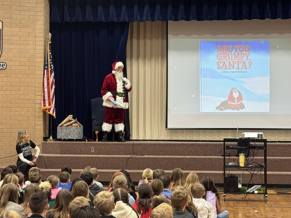 Santa reading a story to students at Maple Ridge.