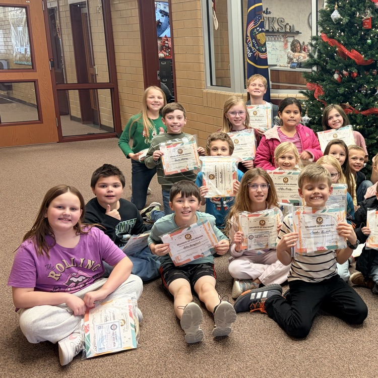 a group of students holding certificates 