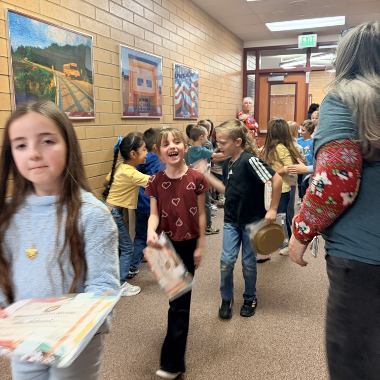 kids walking down the hall while other students cheer them on