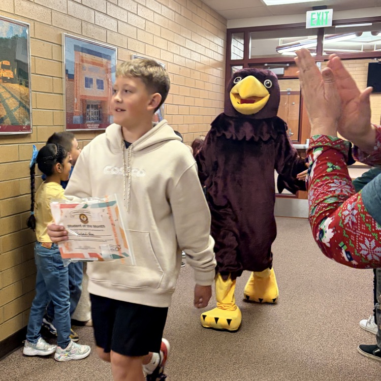 kids walking down the hall while other students cheer them on