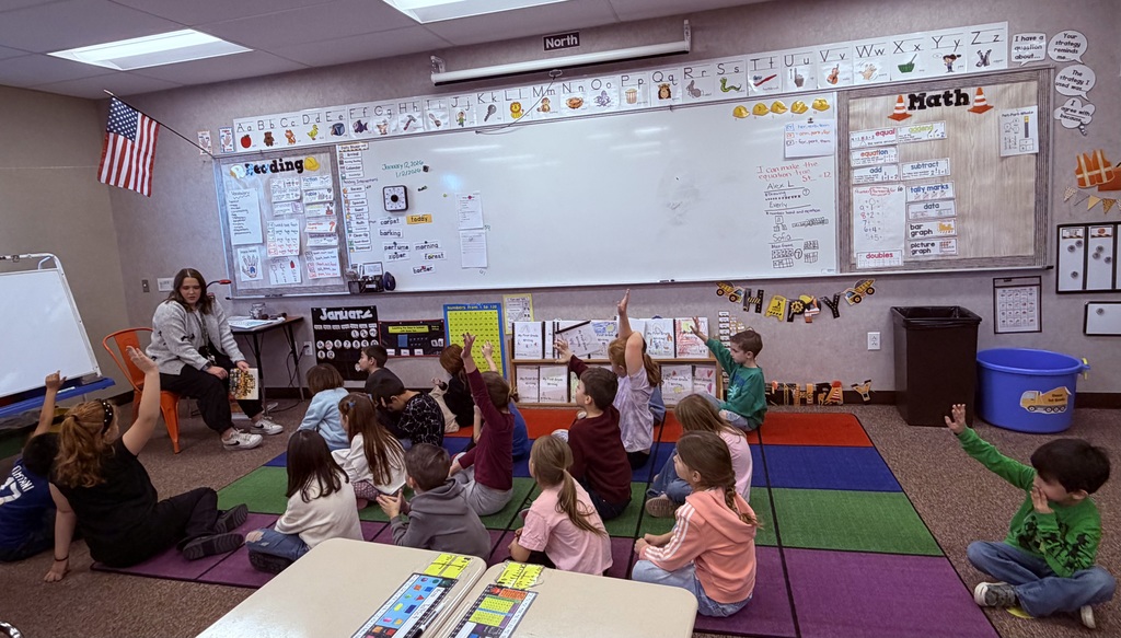 students raising their hand to get called on 
