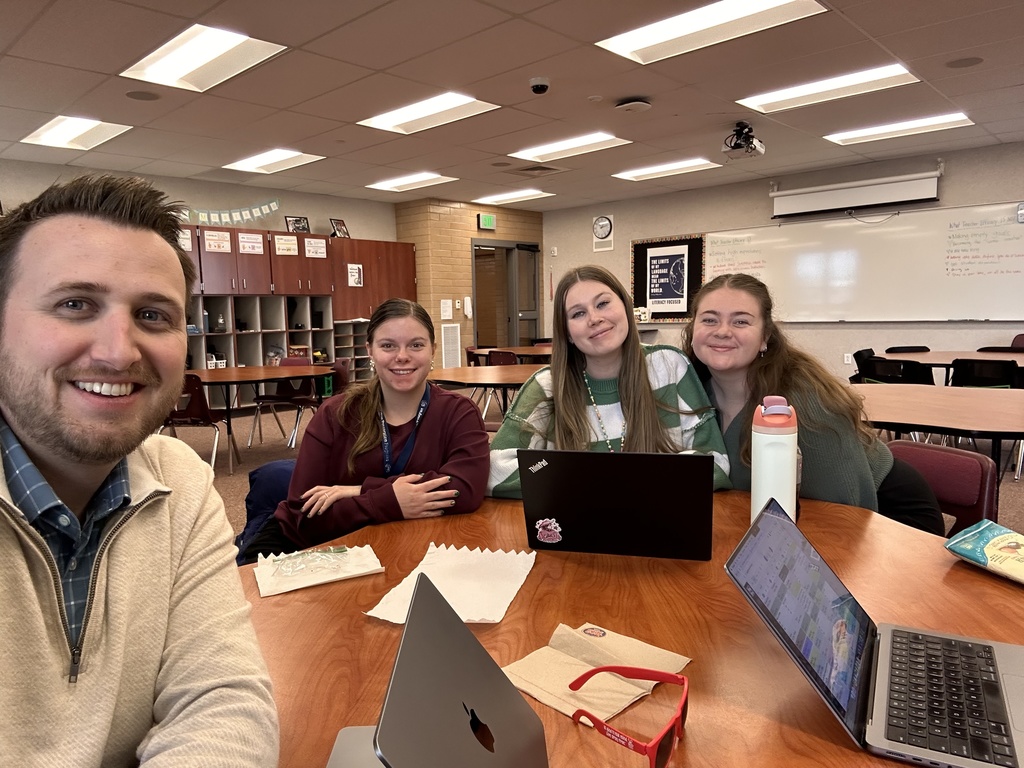 teachers posing with their laptops