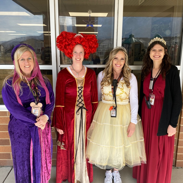 four kindergarten teachers dressed as royalty smiling