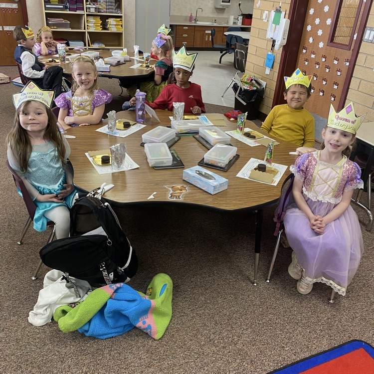 two tables of kids sitting and smiling