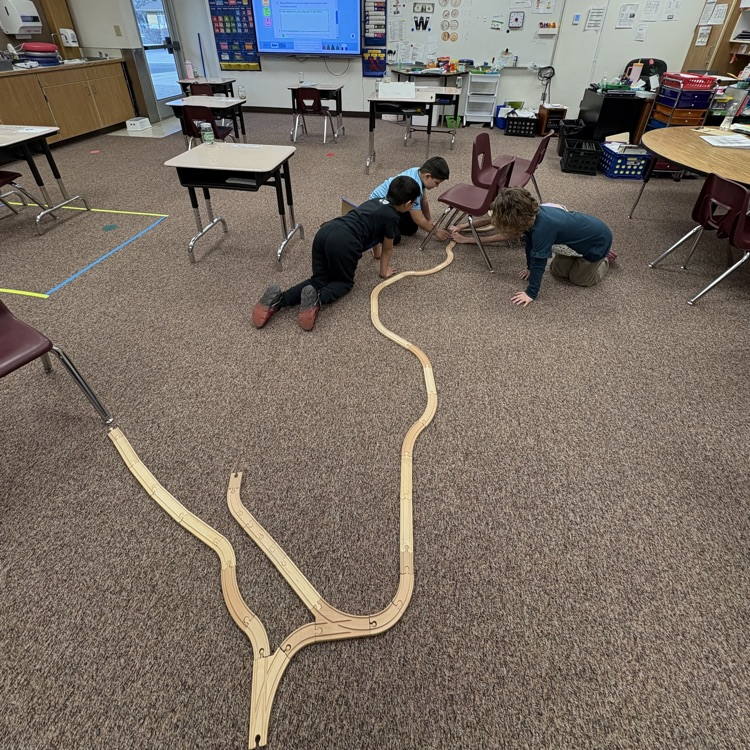 students building a train track depicting the western expansion 