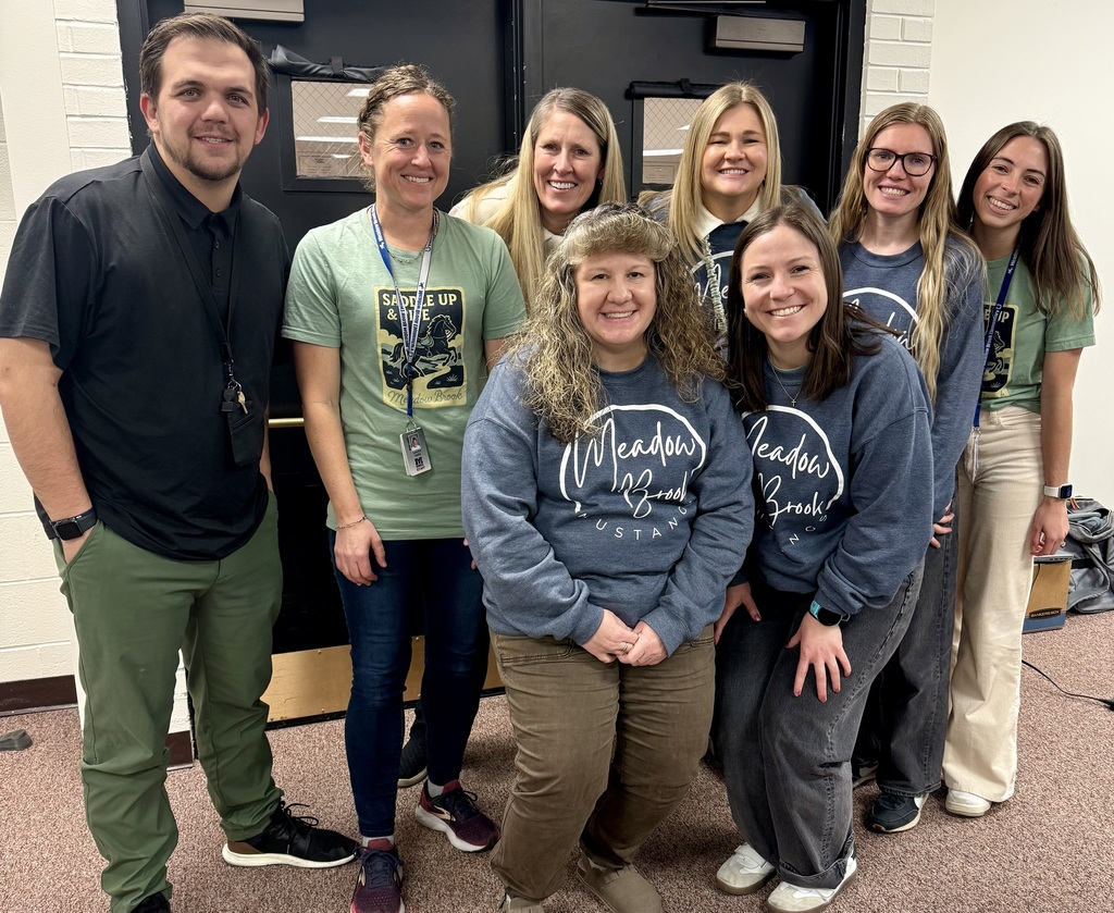 adults posing for a photo smiling together