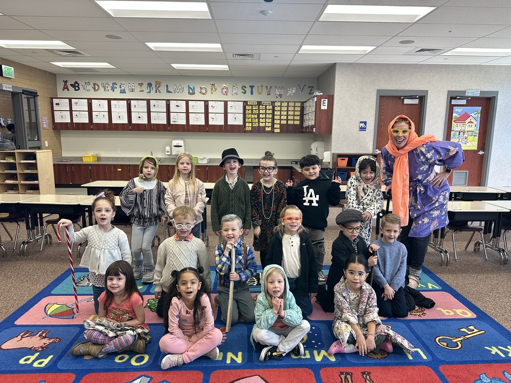 Students dressed up as elderly people posing for a photo