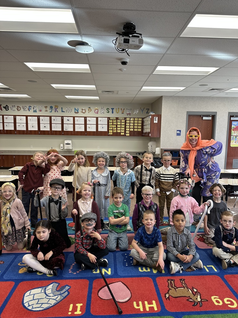 Students dressed up as elderly people posing for a photo