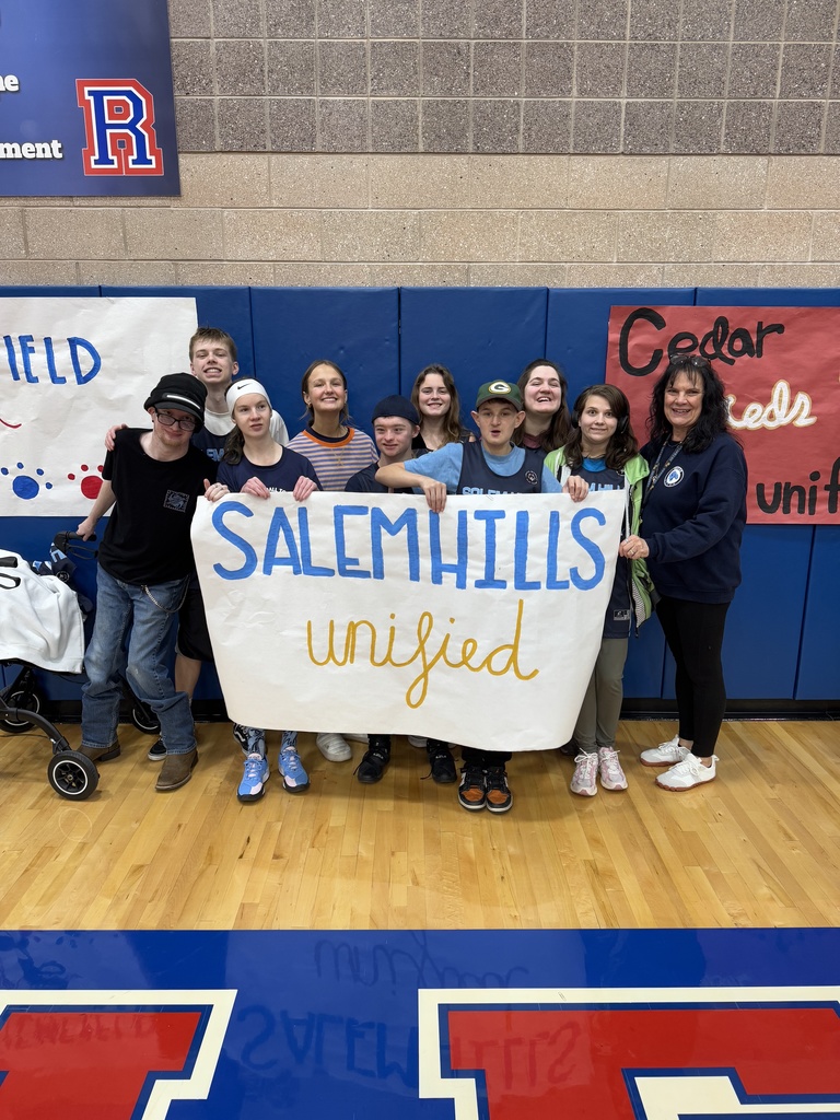 Unified Basketball holding a sign